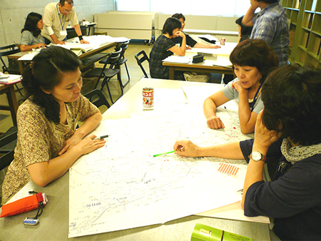災害をテーマにした活動で防災マップを作成中のジンタナさん（手前テーブル左）